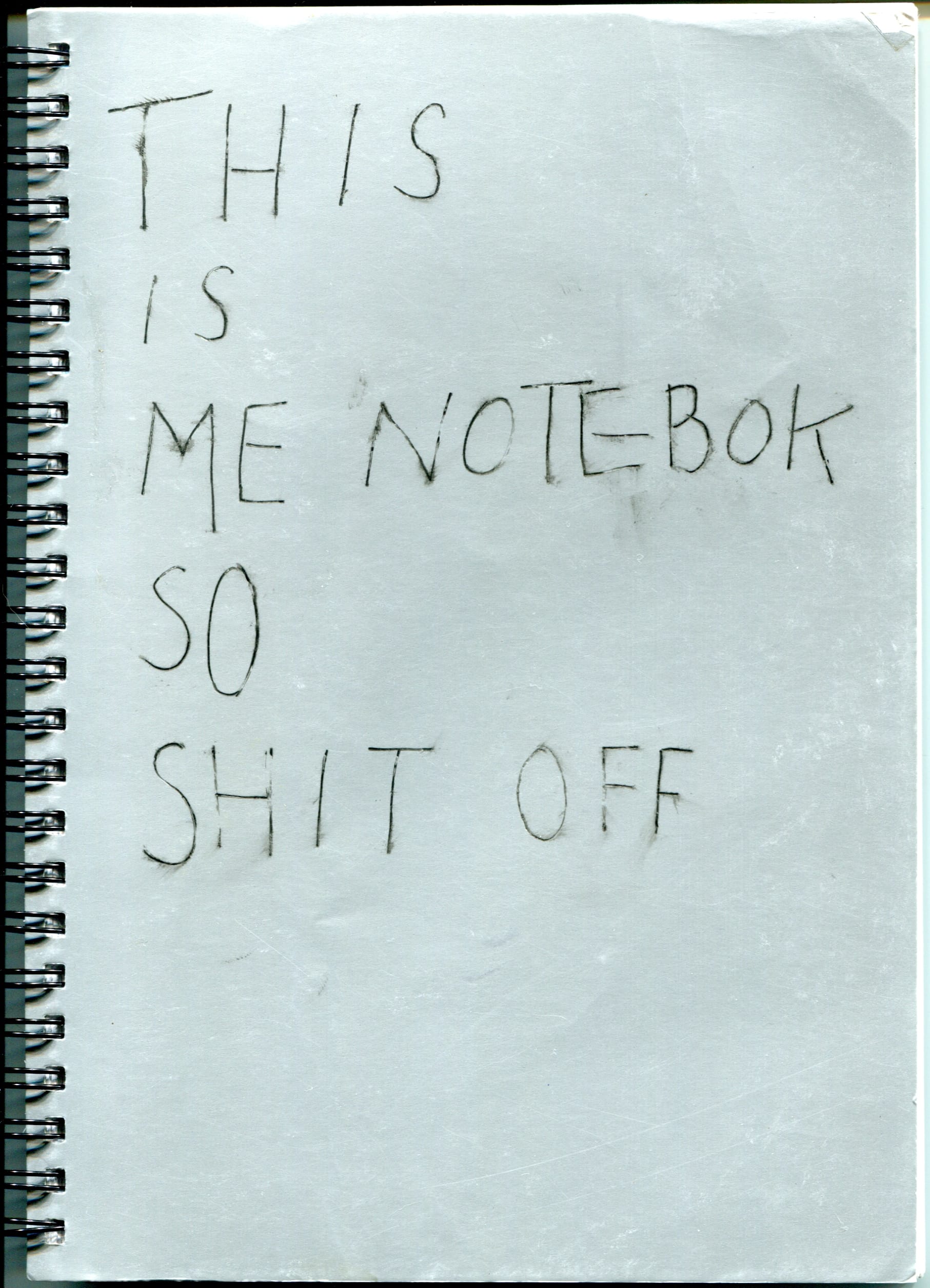 silver cover of a wire-bound notebook