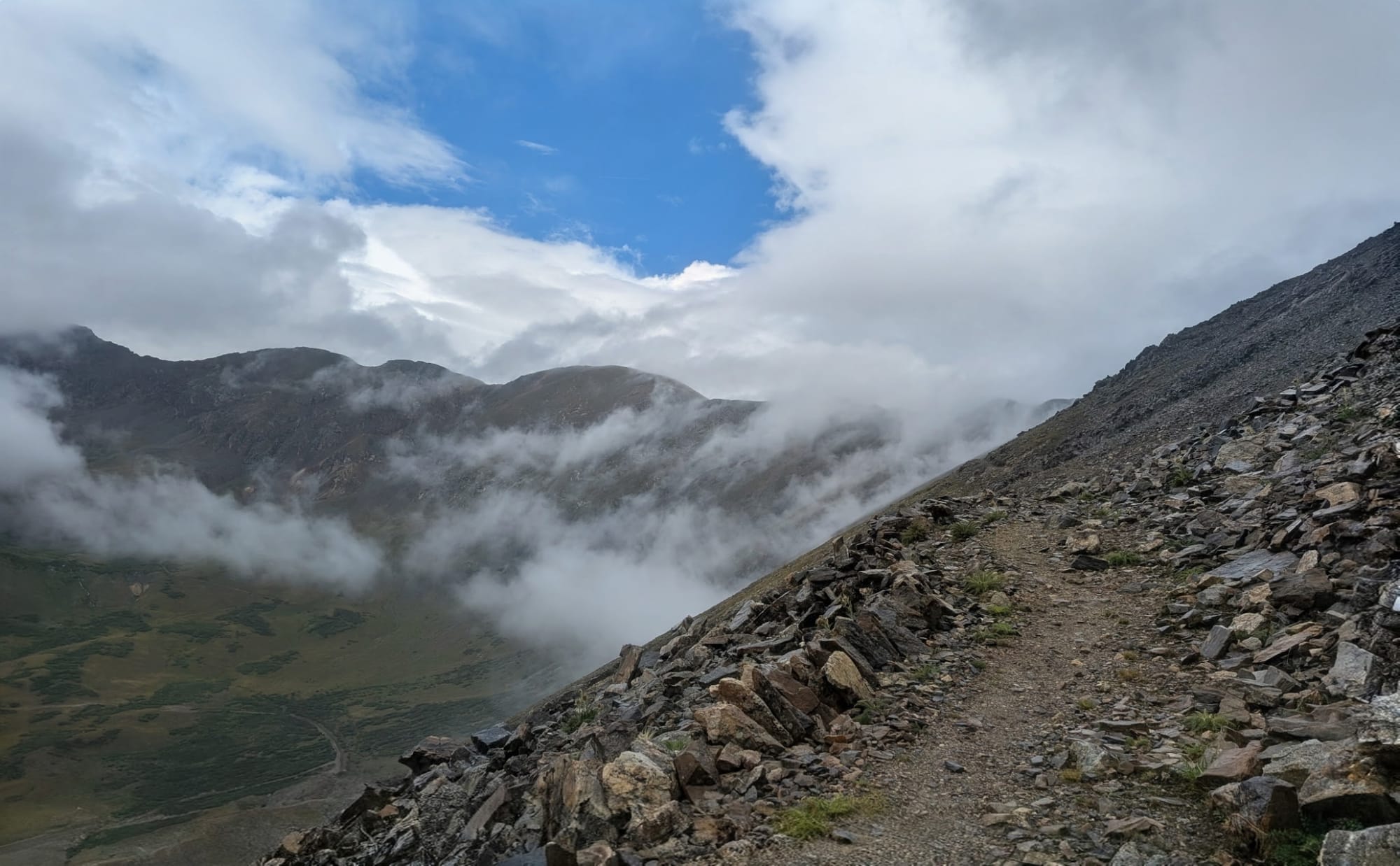 Narrow exposed tread near the summit of Argentine Pass on the American Discovery Trail in Colorado, with the valley dropping away below