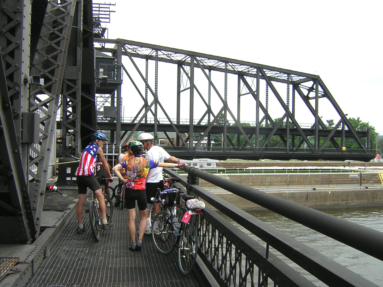 Cyclists waiting on the Government Bridge at Davenport while the swing span is open, at the Iowa–Illinois crossing of the American Discovery Trail