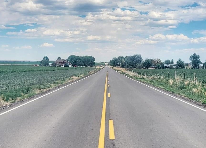 US 34 running straight to the horizon across the open plains of Weld County, Colorado, on the northern route of the American Discovery Trail