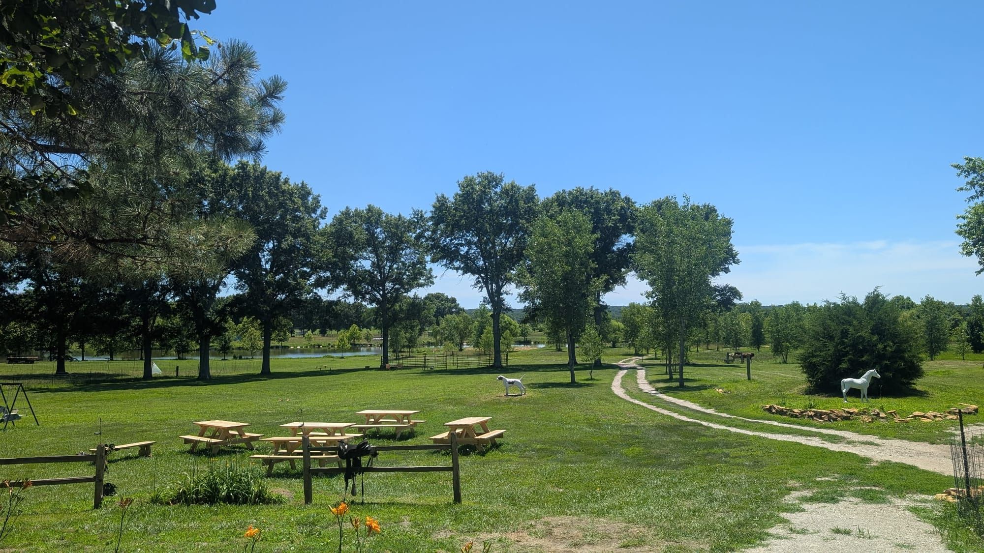 Picnic tables, a lake, a playground at Lake Georgia-Su in Kansas.