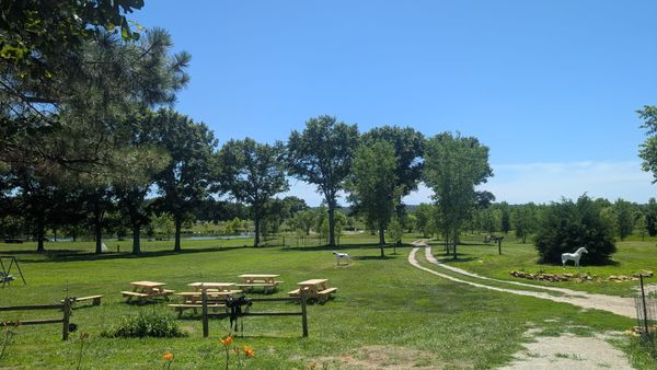 Picnic tables, a lake, a playground at Lake Georgia-Su in Kansas.