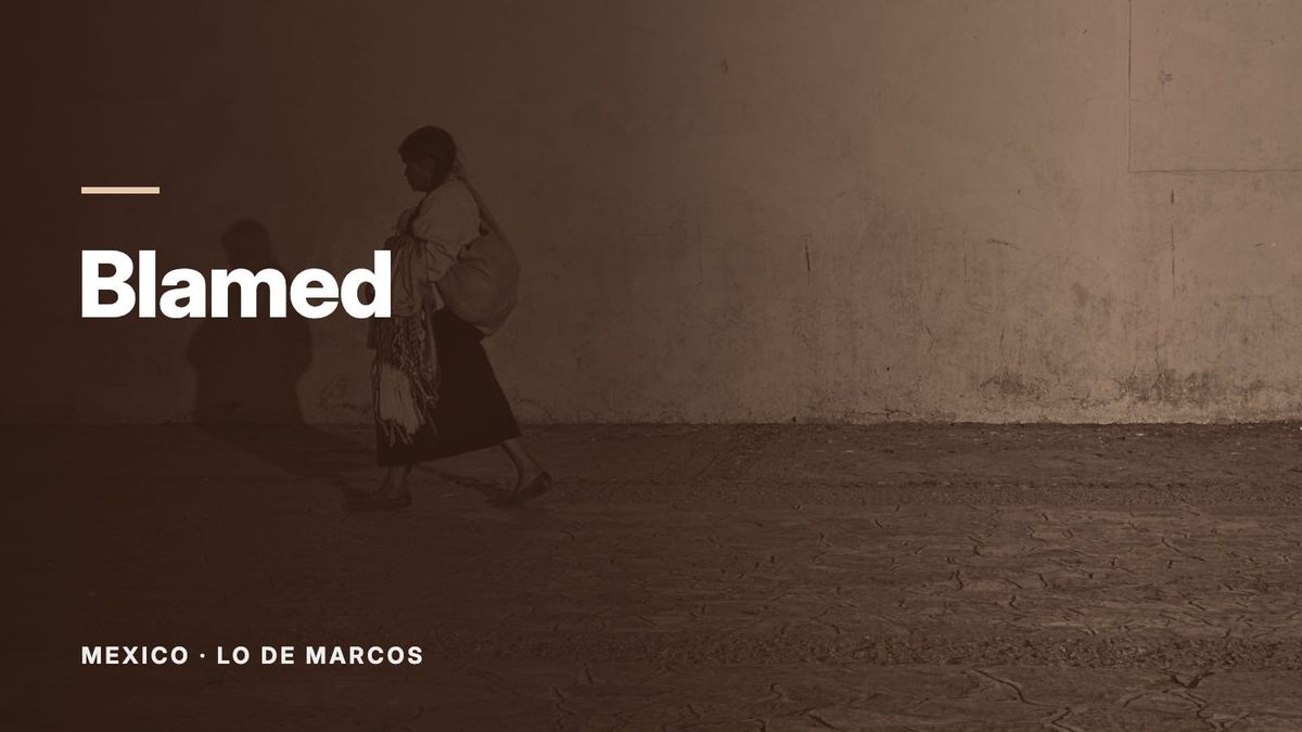 A woman carrying a bundle on her back walks past a yellow wall. Text: “Blamed”, Mexico: Lo de Marcos.