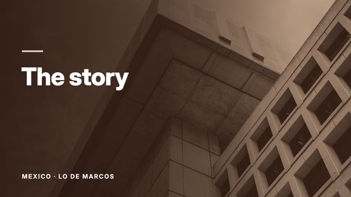 The corner of a concrete building against a blue sky, seen from below. Text: “The story”, Mexico: Lo de Marcos.