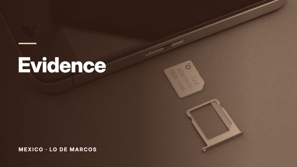 A SIM card and its tray lying beside a mobile phone. Text: “Evidence”, Mexico: Lo de Marcos.
