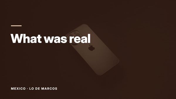 A silver phone lying on a black table. Text: “What was real”, Mexico: Lo de Marcos.