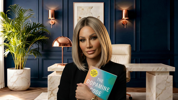Dr. Sydney Ceruto holding her new book, The Dopamine Code, in her office — out today.