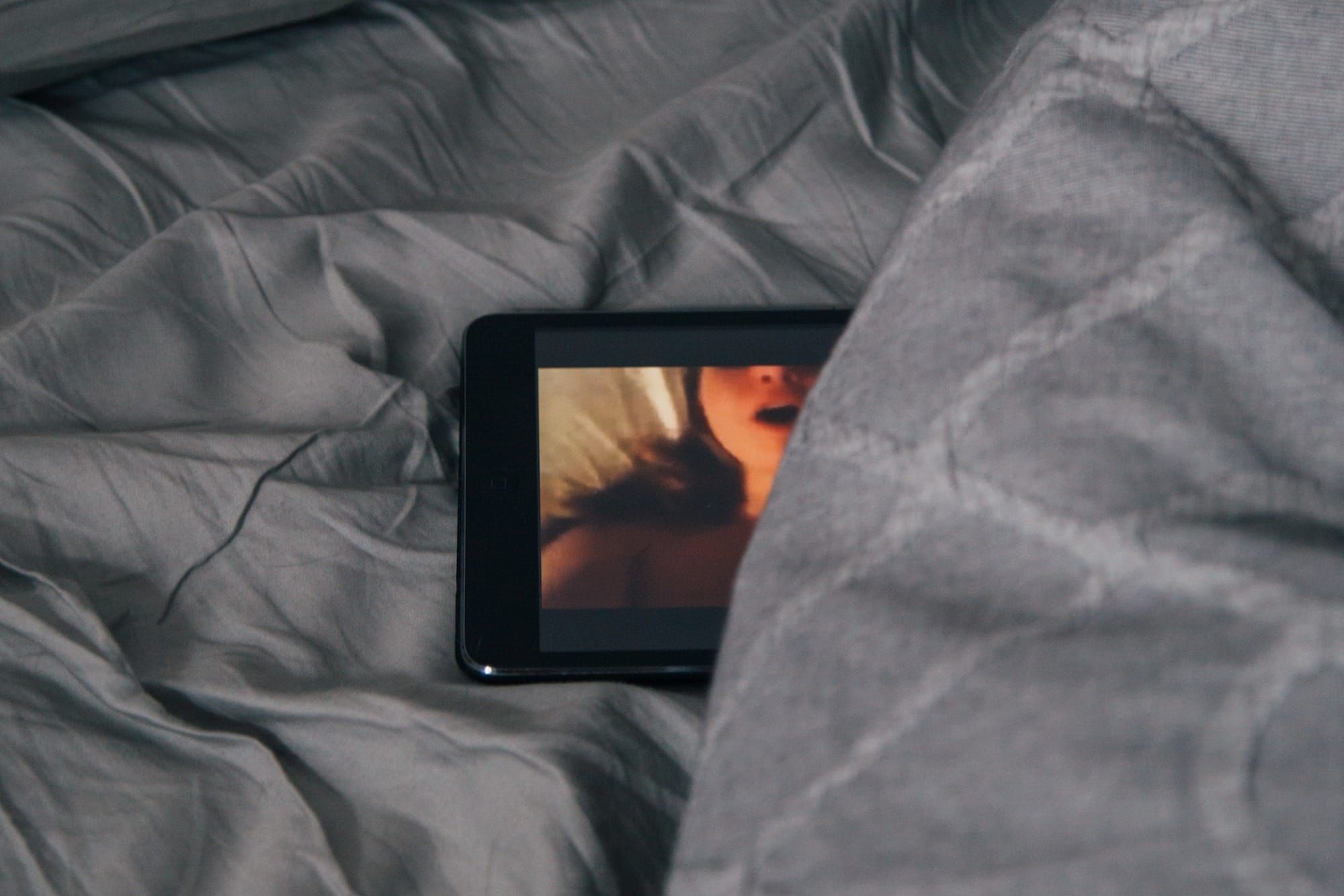 A tablet on a bed 
