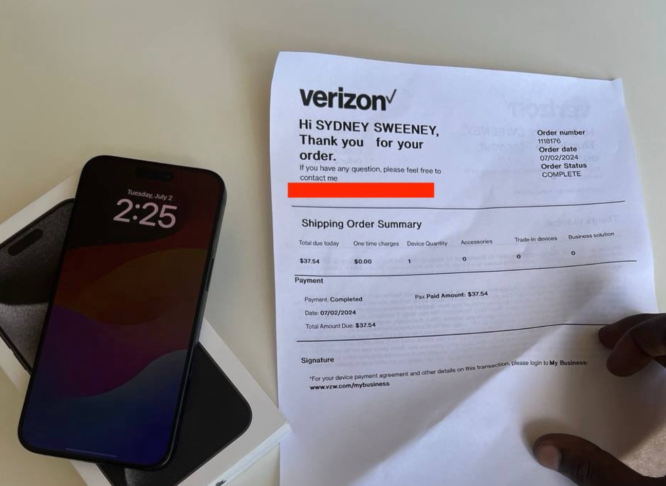 The receipt includes Sydney Sweeney's name. The photo also shows an iPhone laying on a car trunk.