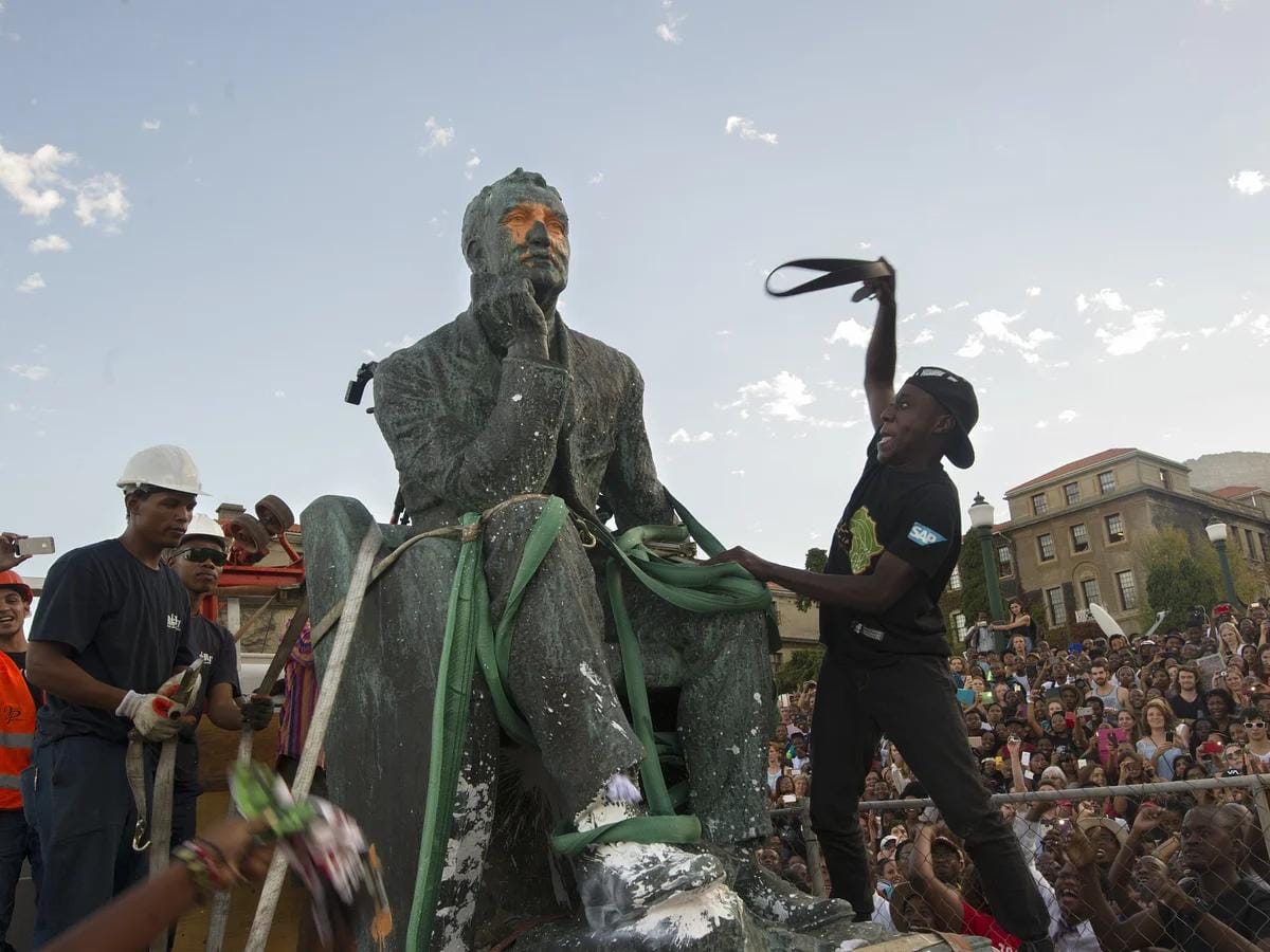 Crowd watches as the Cecil Rhodes statue is lifted from its plinth