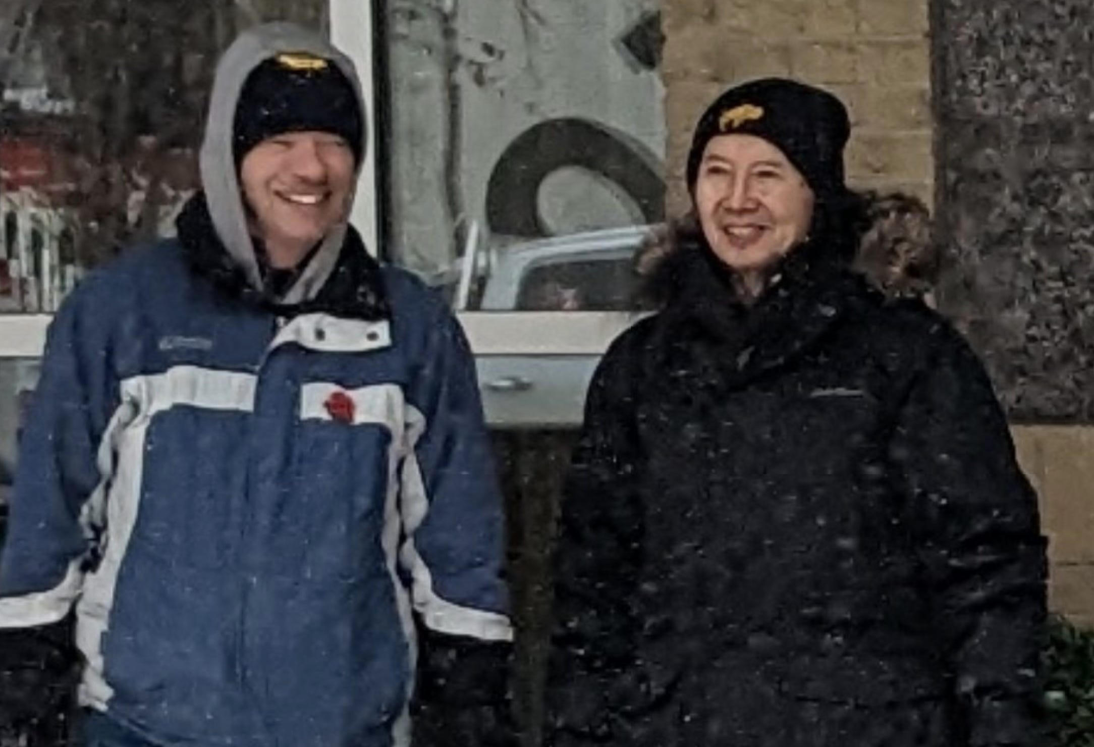Close-up of the previous photo showing two men chatting together with a window in the background. They are members of the Calgary freedom guardians