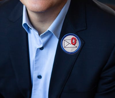 man's blazer lapel with inbox zero patch from nerd merit badges