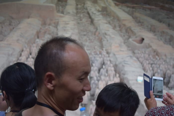 photo of terra cotta warriors in xian china where the focus and most of the frame is some guy