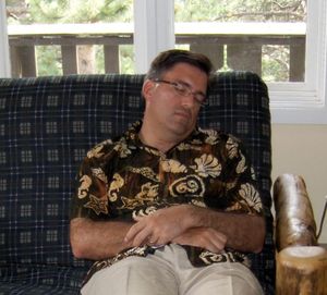 Guy in a Mad Gringo shirt sleeping but listening