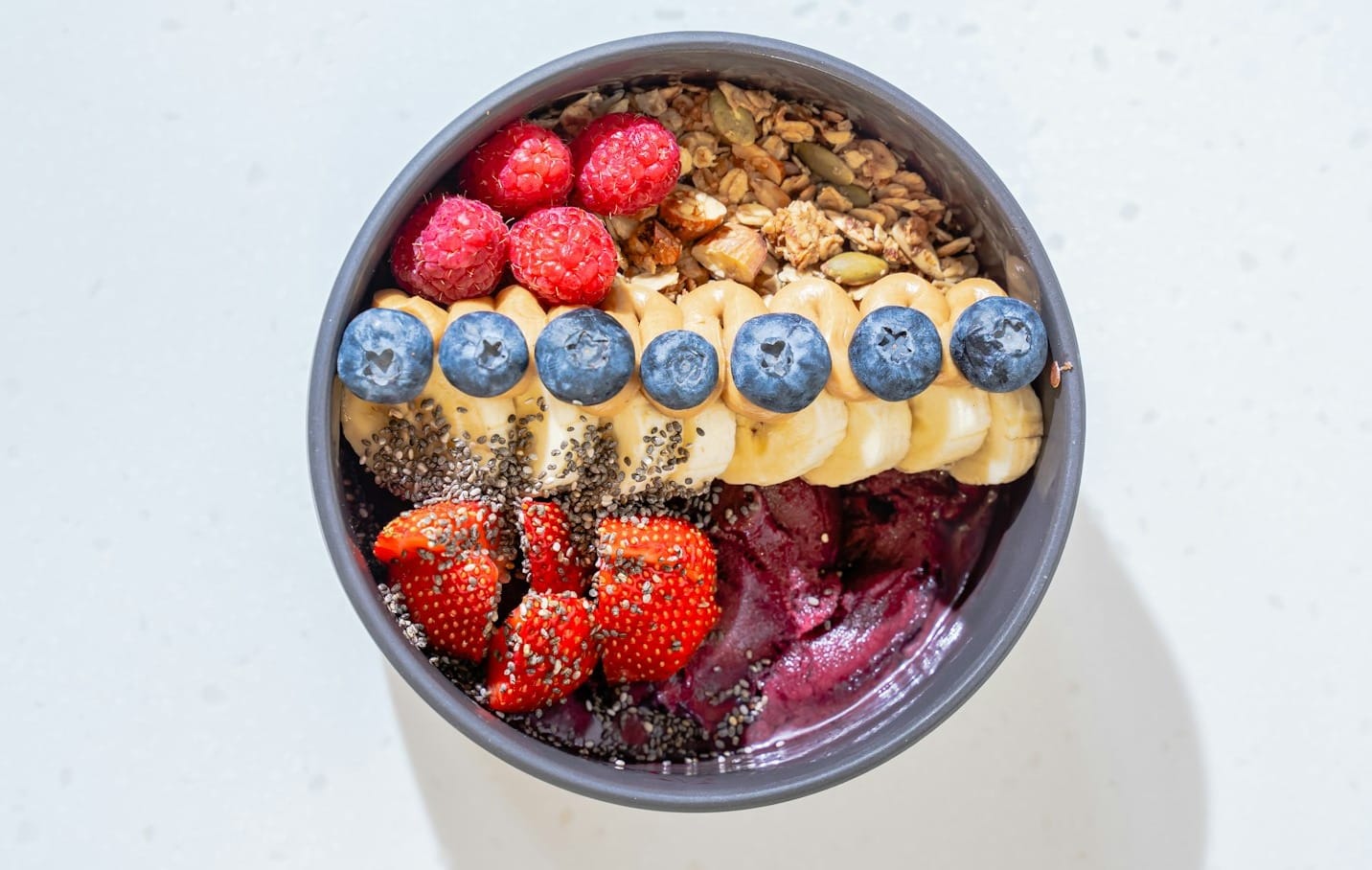 a bowl of cereal with milk and fruit