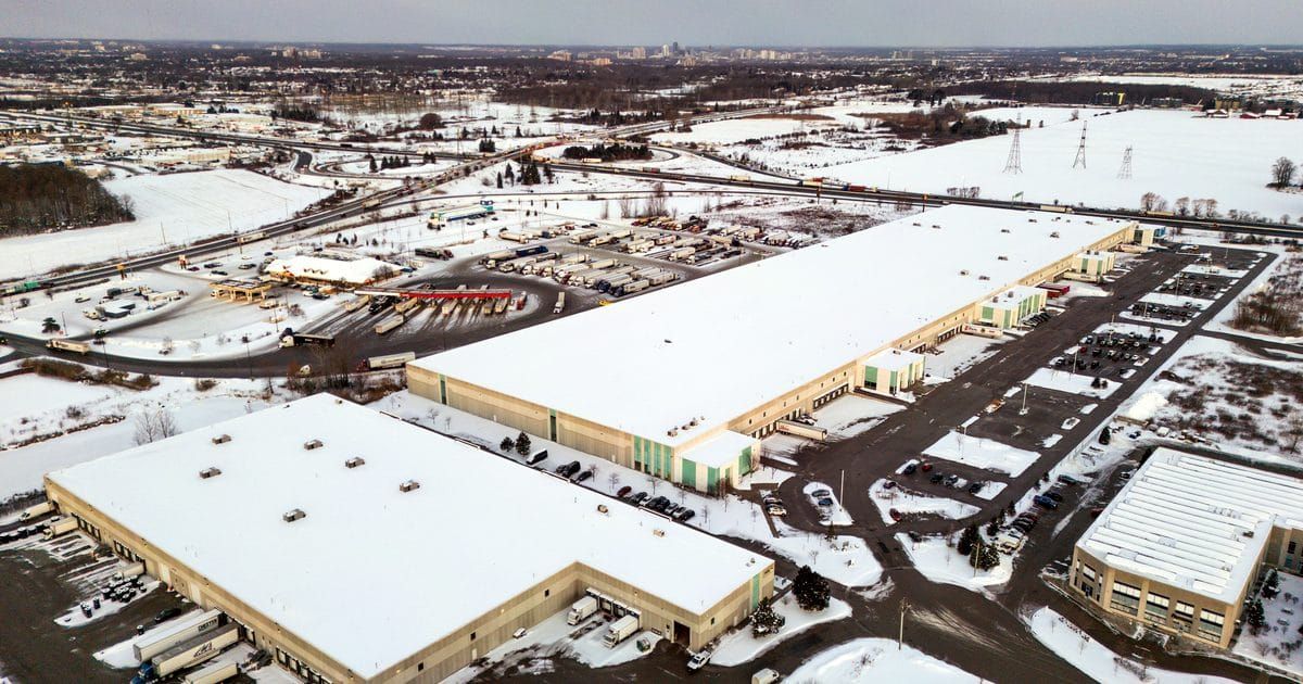 Aerial view of large distribution warehouses with loading docks in winter