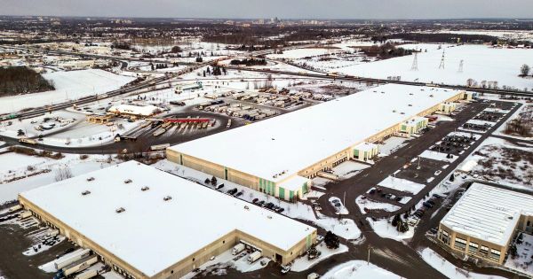 Aerial view of large distribution warehouses with loading docks in winter