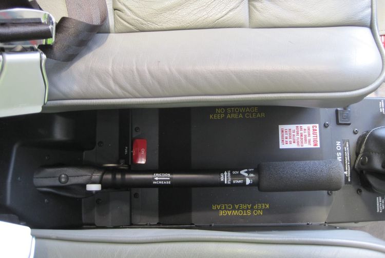 View from above of the collective lever and throttle of a Robinson R44 helicopter