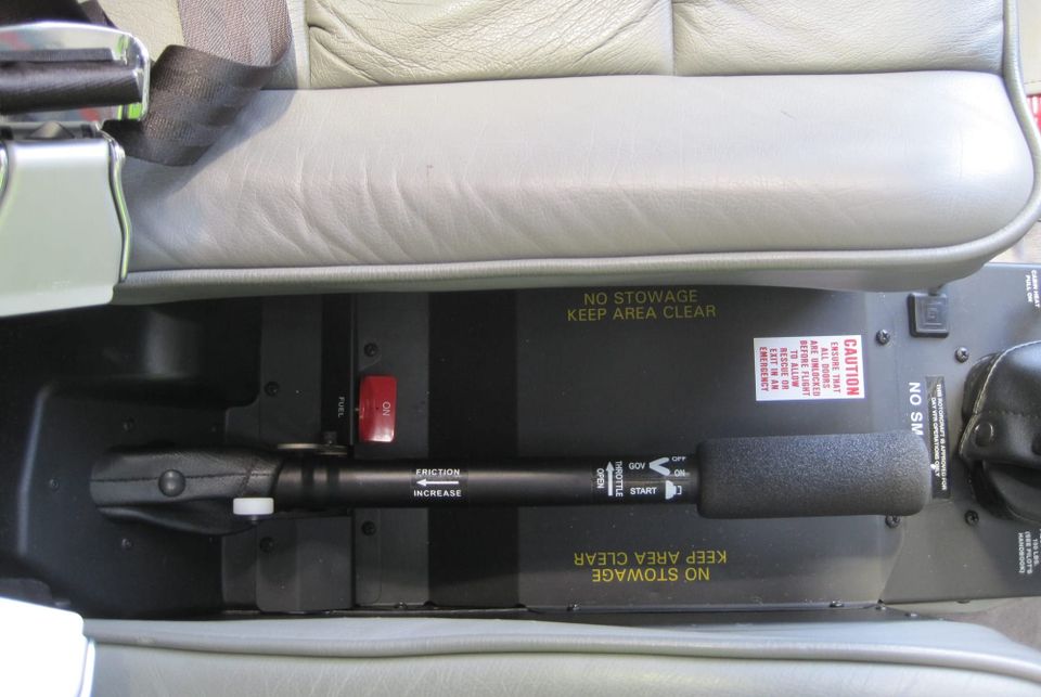 View from above of the collective lever and throttle of a Robinson R44 helicopter