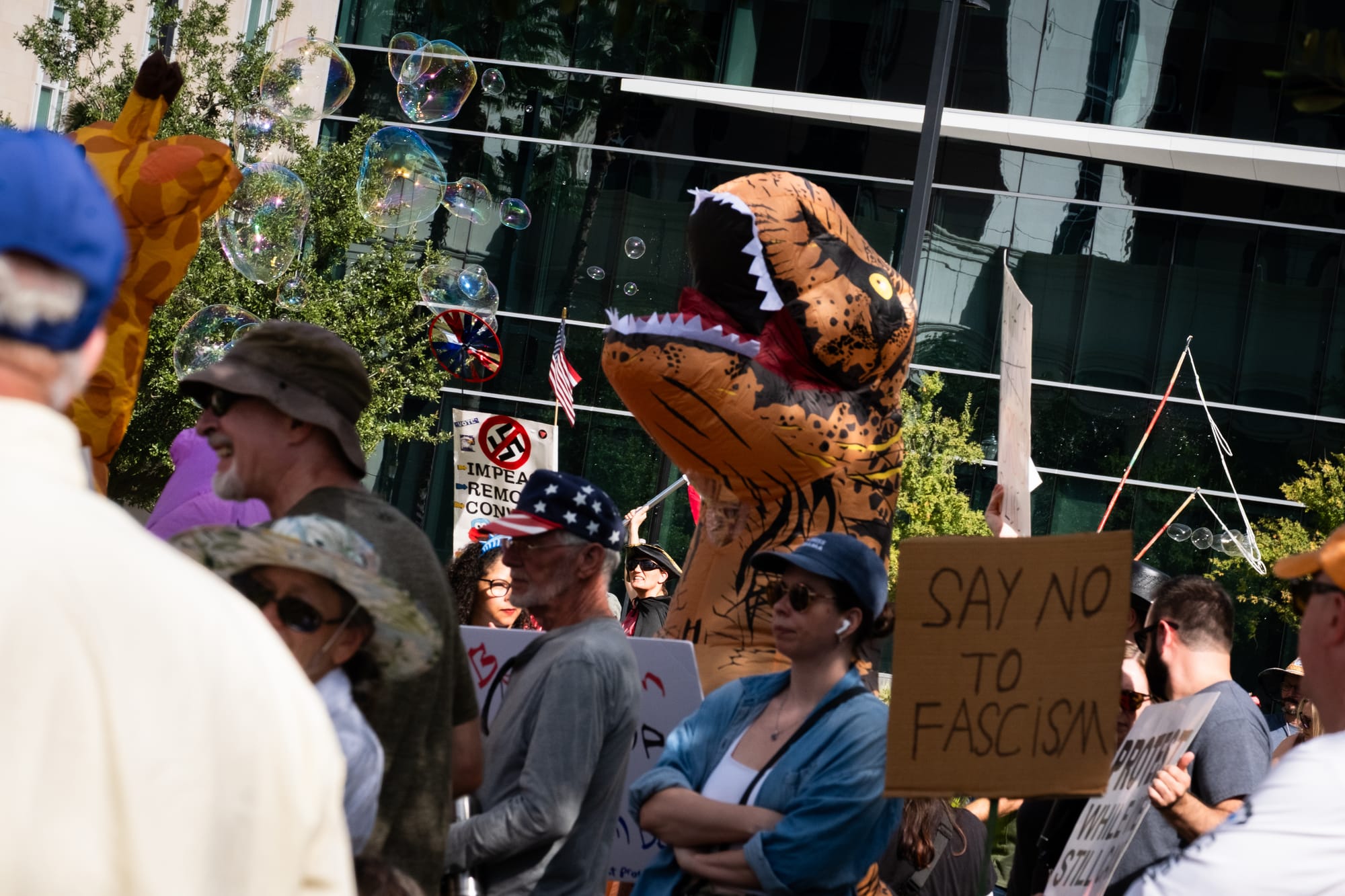 Protestor in blow up T-Rex costume
