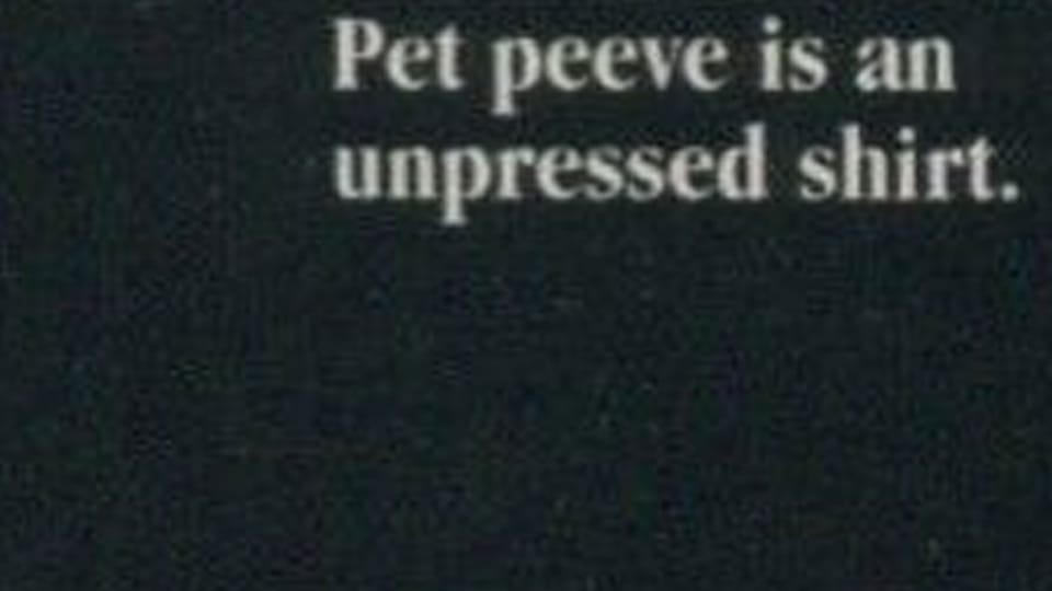 Blurred white type on a dark grey background: 'Pet peeve is an unpressed shirt.'