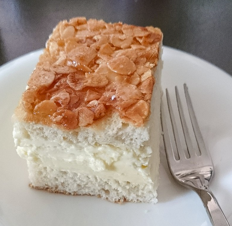 Bee sting cake, a German dessert cake made of a sweet yeast dough with a baked-on topping of caramelized almonds and filled with vanilla custard, buttercream, or cream