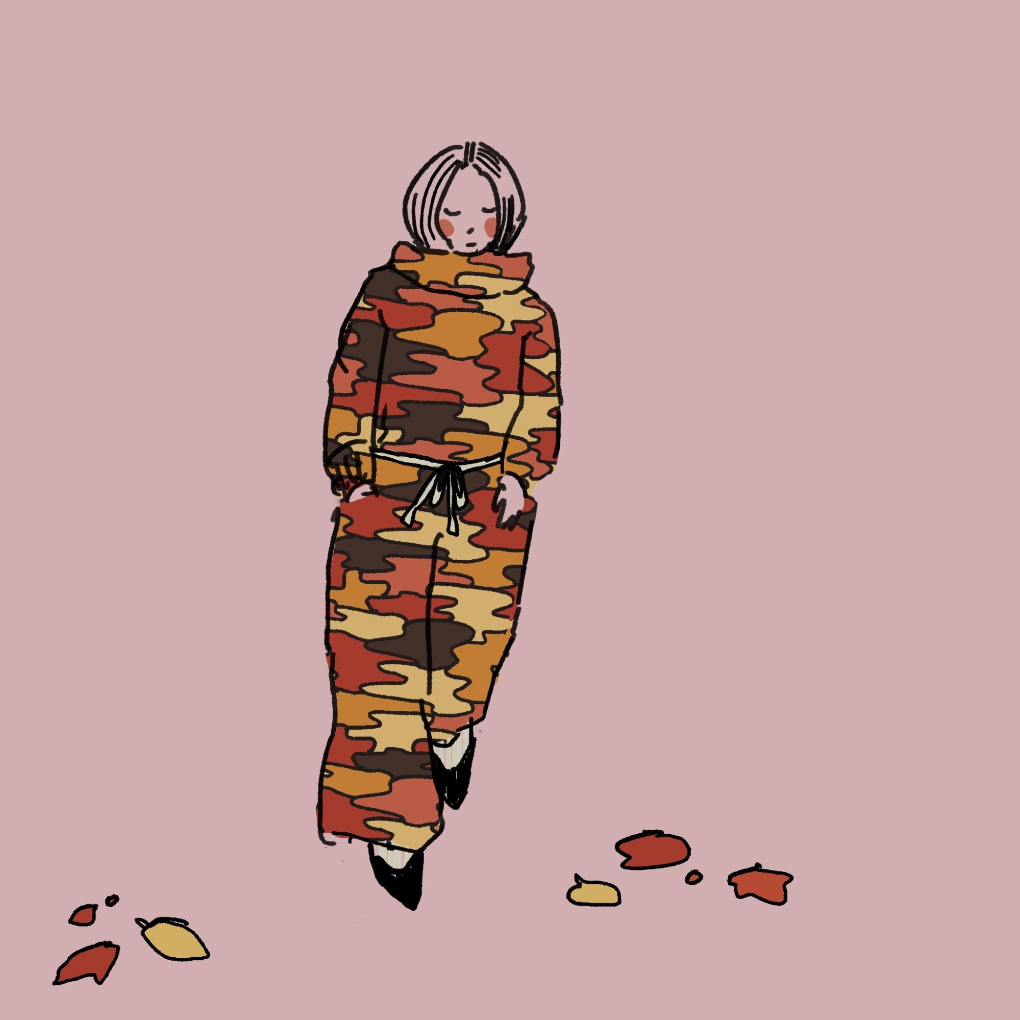 Gravely elegant lady in a long robelike dress resembling a monk's robe in a camouflage-ish pattern of fall colors