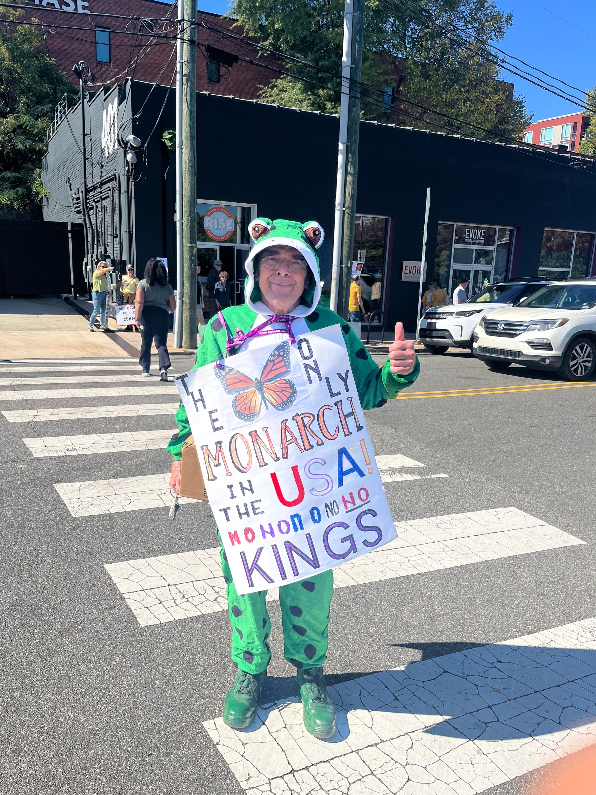 Man in frog suit with sign depicting a butterfly: "The Only Monarch in the USA! NO NO NO NO NO KINGS"