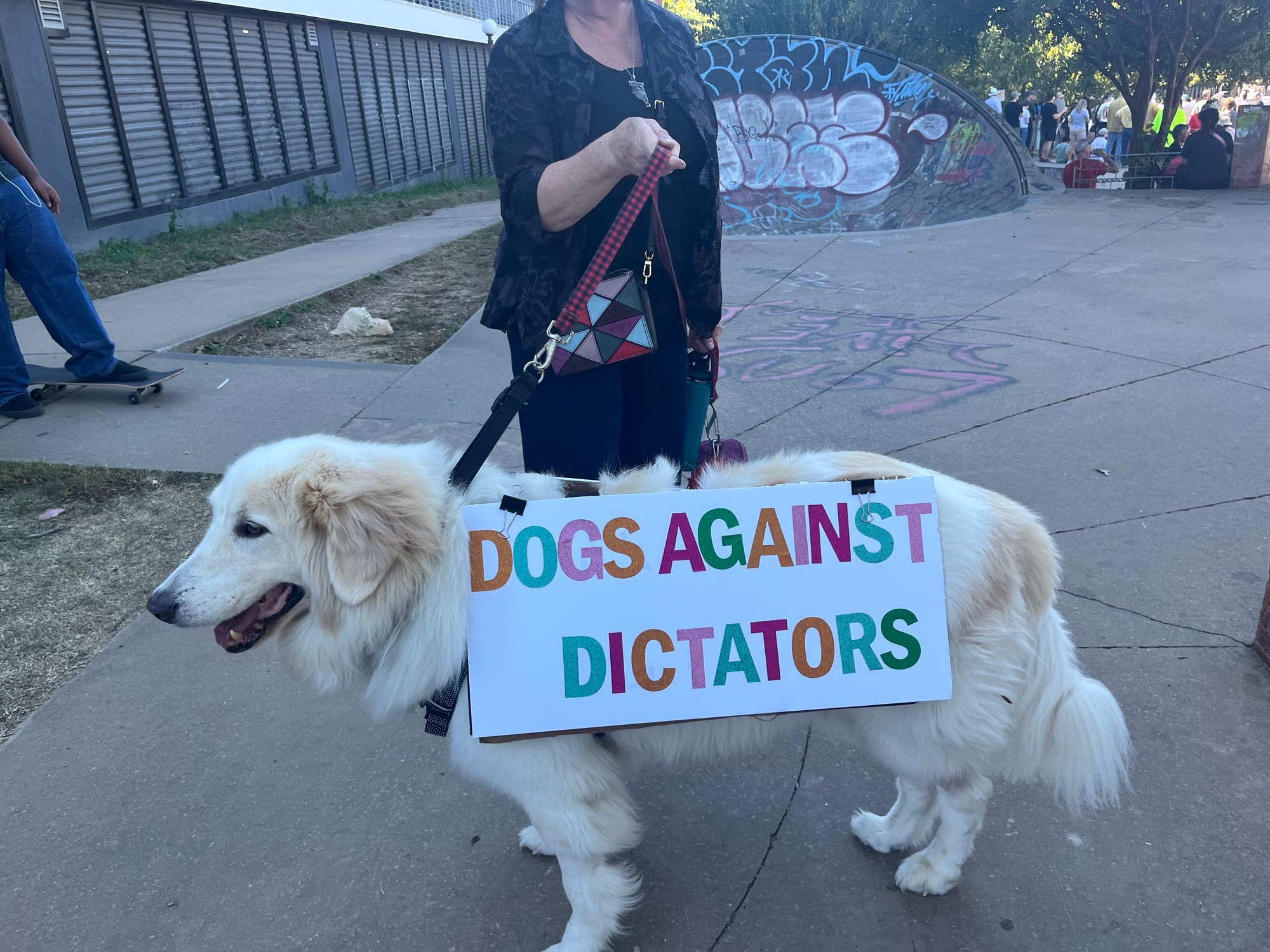 Large Retriever with a sign: DOGS AGAINST DICTATORS