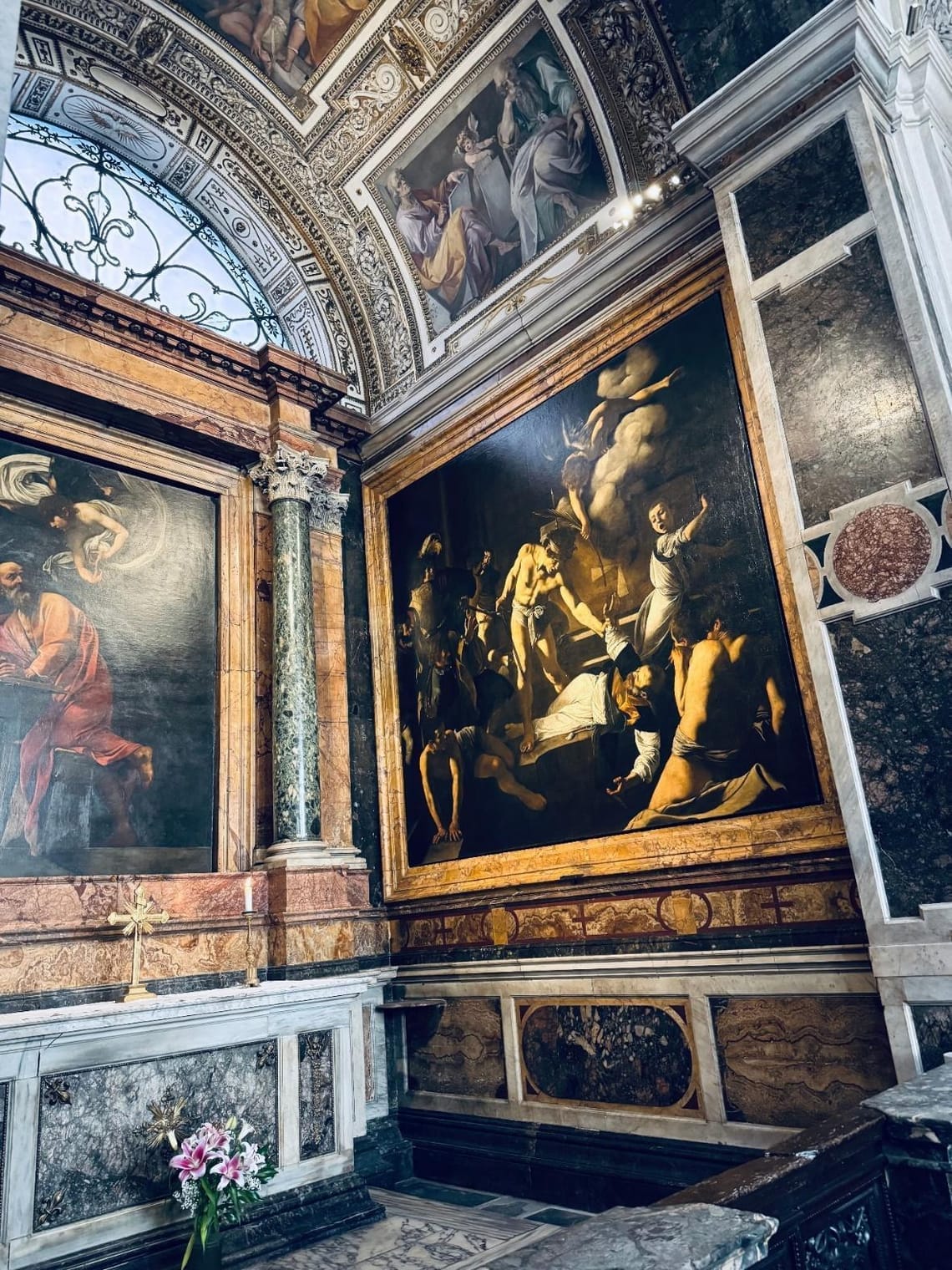 The ornately decorated marble Contarelli Chapel (1590) showing Caravaggio's 'The Martyrdom of St. Matthew' (1599)