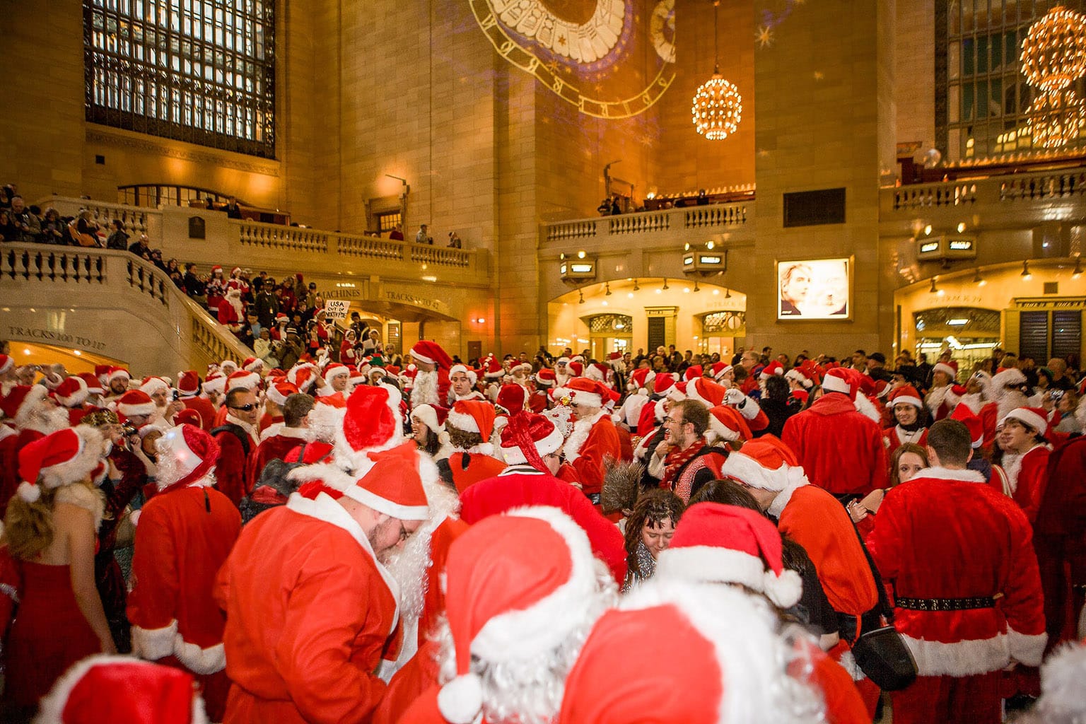 Huge crowd of Santas in the train station