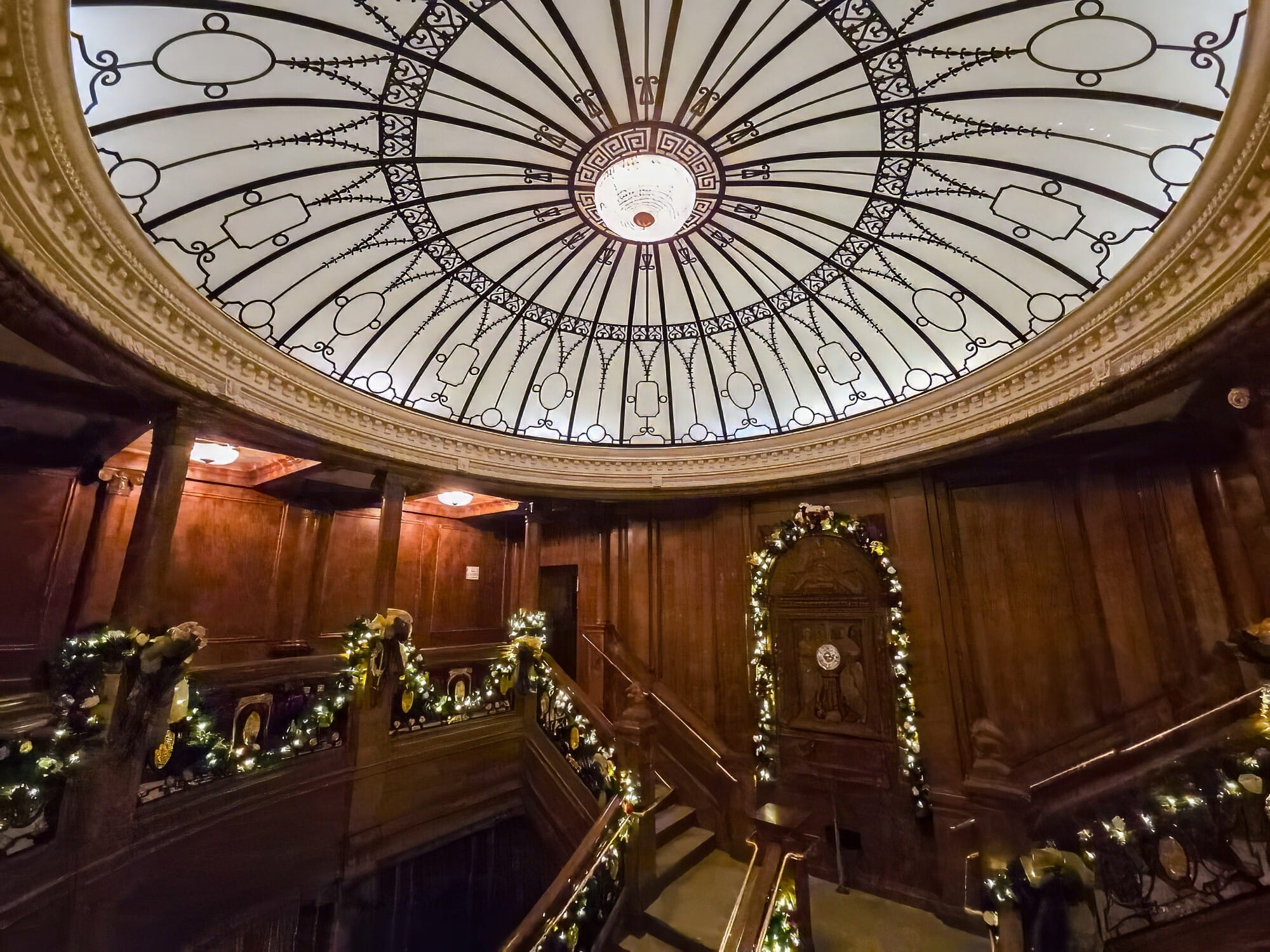 Reproduction of the Titanic's grand staircase, with stained glass dome above and loads of wood paneling, plus Christmas decorations