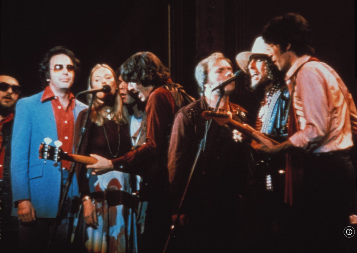 Rock icons of the 1970s gathered on the stage, wearing ultra 1970s clothes, clustered around two microphones, making both film and music history
