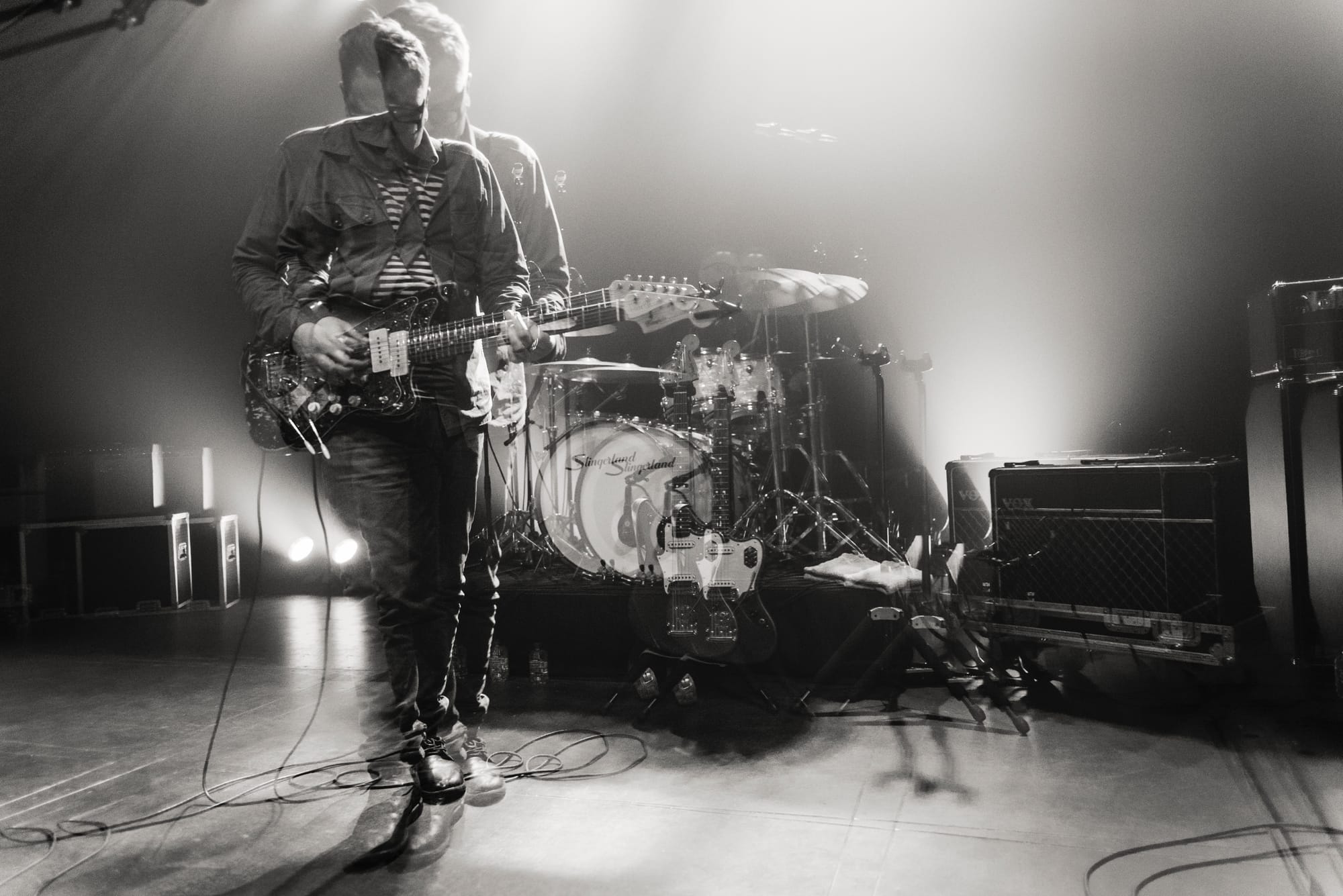 Black and white multiple exposure of Aaron Perrino on electric guitar