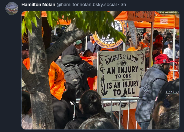 Bluesky post from Hamilton Nolan: [IMAGE] of a crowded labor gathering with a big sign reading KNIGHTS OF LABOR: AN INJURY TO ONE IS AN INJURY TO ALL