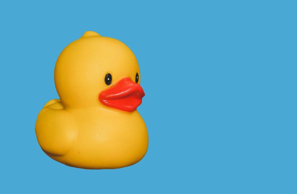 a nice little yellow rubber ducky on a ground of clear blue