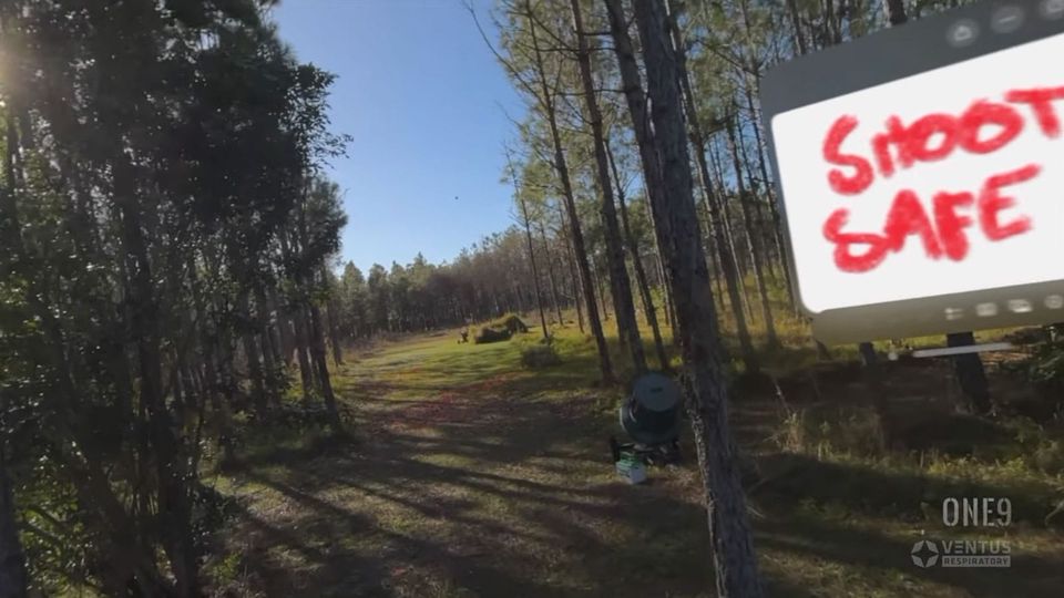 Computer menu display reading "SHOOT SAFE" over the right-hand side of a forest scene in a Vision Pro image