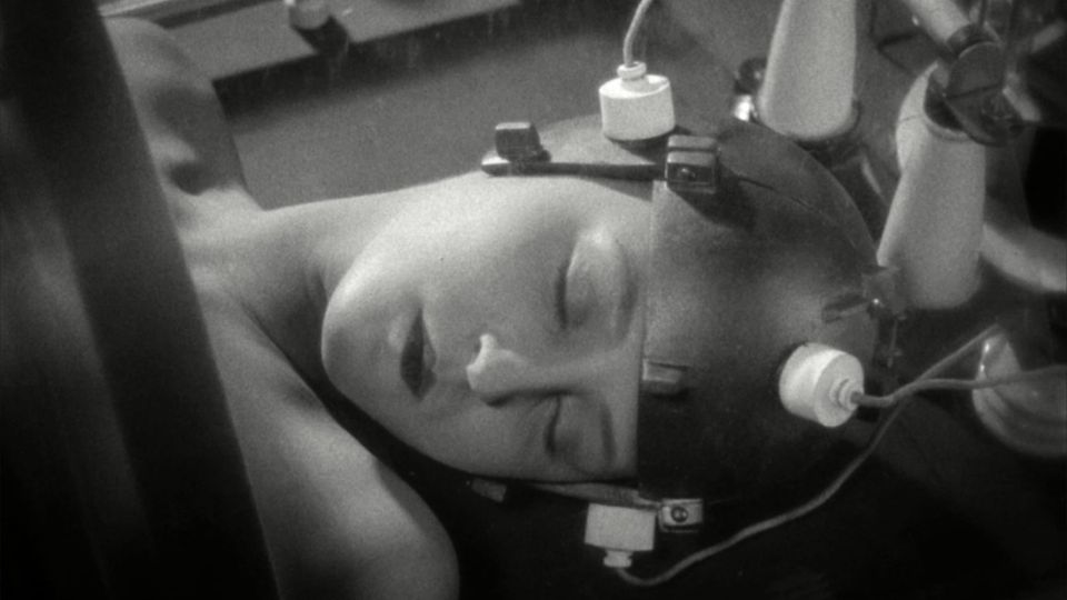 Still b/w image from Fritz Lang's 1927 'Metropolis' shows a sleeping figure in a helmet with wires