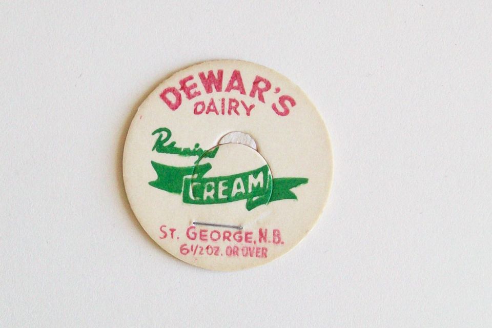 Vintage bottle cap in red and green on cream paper: "DEWAR'S DAIRY Pasteurized CREAM, ST. GEORGE, N.B. 6 1/2 OZ. OR OVER"