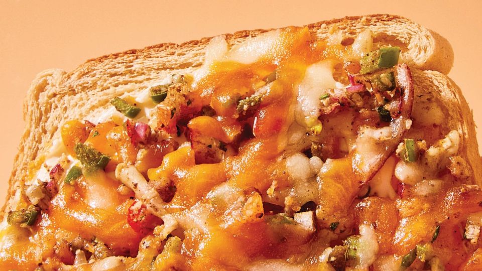 Scrumptious looking Chili Cheese Toast, with melted cheese, bits of pepper, onion and spices