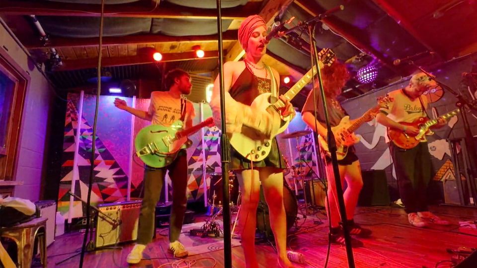 Colorful club stage with Ekko Astral performing in 2024 in Austin, via Stereogum