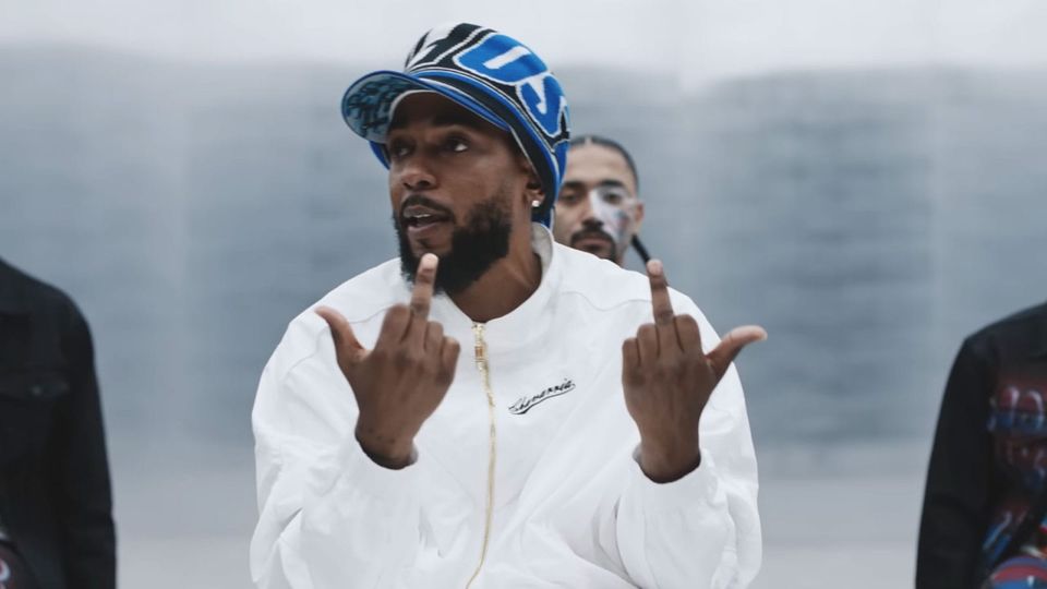 Kendrick Lamar in a screenshot from the video of 'Not Like Us', giving a double middle finger