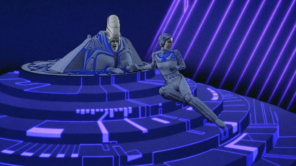 tiered purple dais, highly stylized bearded ruler at wearing tall cylindrical crown; at his side a helmeted lady reclines in a skin-tight bodysuit; she is holding his hand