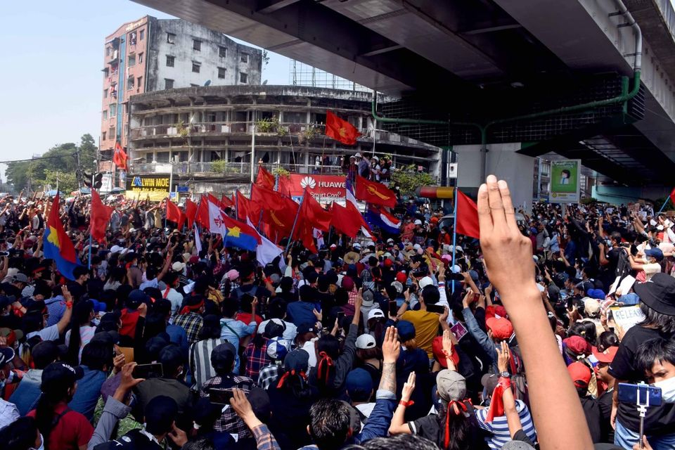 Protesters, many raising their hands in the Hunger Games pro-democracy salute, at an anti-military rally in downtown Yangon 