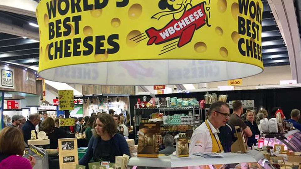 From the 2016 Winter Fancy Food Show, a display of World's Best Cheeses from WBCHEESE, in a crowded convention hall