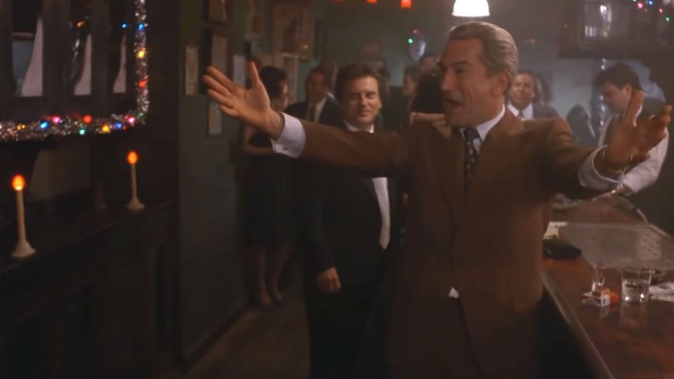 Robert DeNiro as Jimmy Conway in 'Goodfellas', arms outstretched to greet his colleagues after the heist