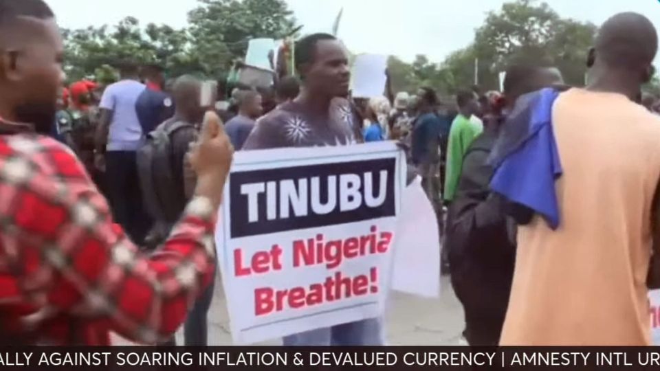 August 1st protestors in Nigeria, one holding a banner reading "TINUBU Let Nigeria Breathe!"