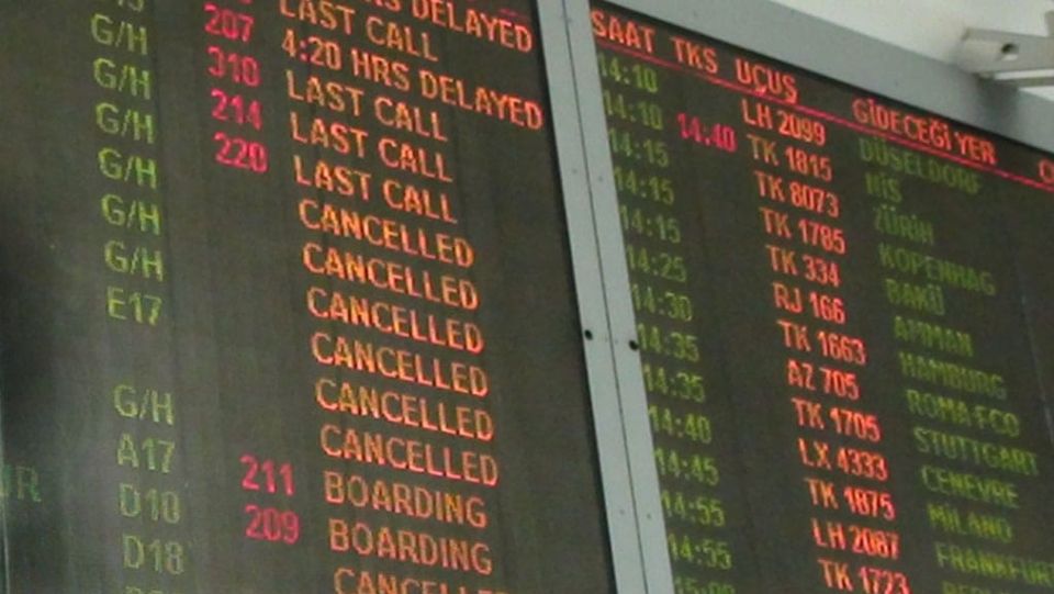 An airport display showing a lot of flights cancelled