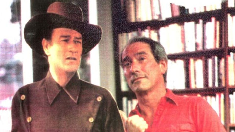 The real Bob Klein and the cardboard John Wayne at the entrance to Sam: Johnson's Book Shop