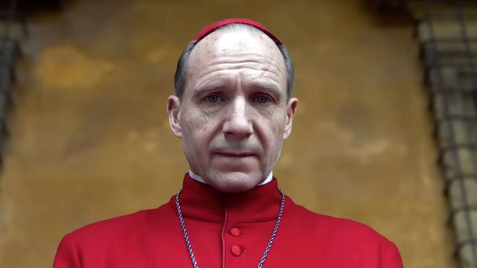 Ralph Fiennes, in red vestments and zucchetto, stars as Cardinal Thomas Lawrence in Conclave